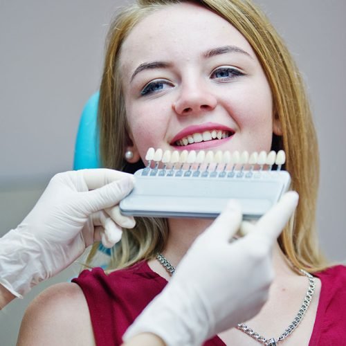 Patient getting a veneer shade match at Gentle Dental Family Care in Queens, NY